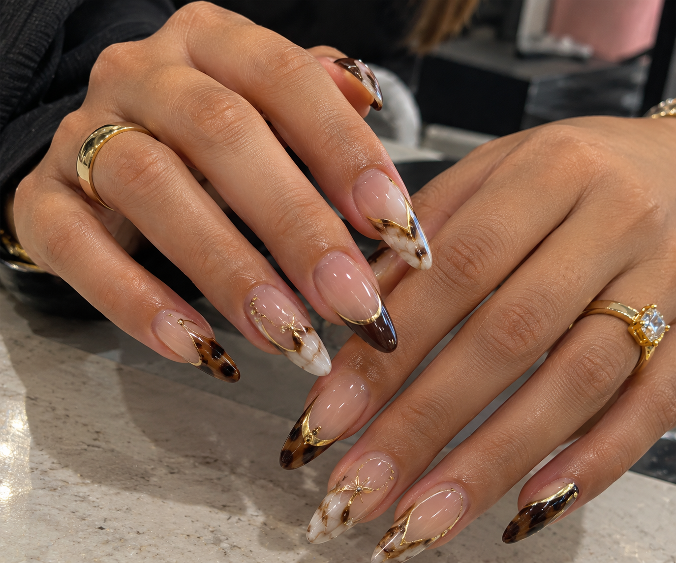 Unhas com detalhes dourados, efeito mármore e pontas decoradas